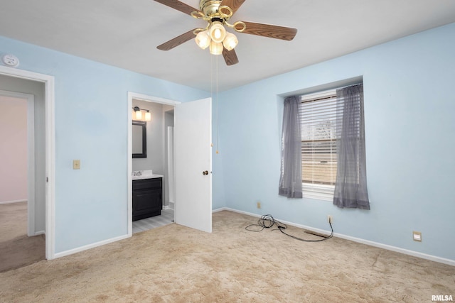 unfurnished bedroom featuring ceiling fan, light colored carpet, baseboards, and connected bathroom