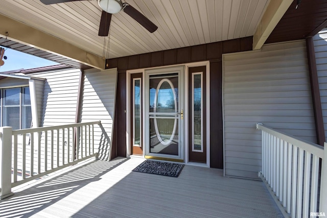 view of exterior entry with a ceiling fan