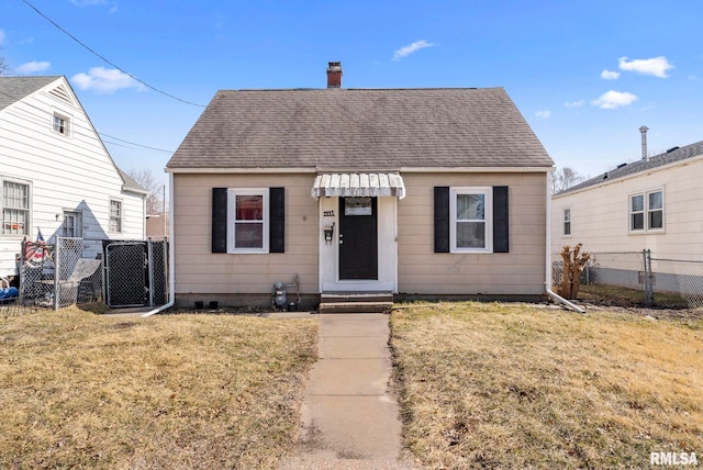 bungalow-style house with a front lawn, fence, roof with shingles, central AC unit, and a chimney