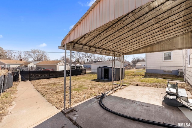 view of yard with a shed, fence private yard, cooling unit, an outdoor structure, and a patio area