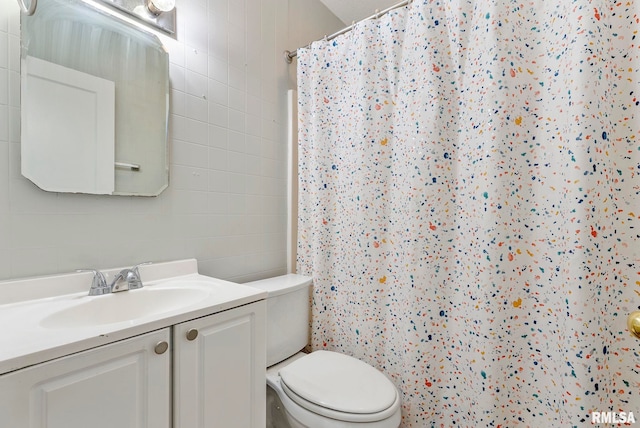 full bathroom with vanity, tile walls, toilet, and a shower with curtain