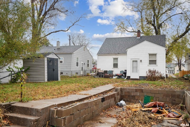 back of property featuring a shed, a chimney, an outdoor structure, and fence