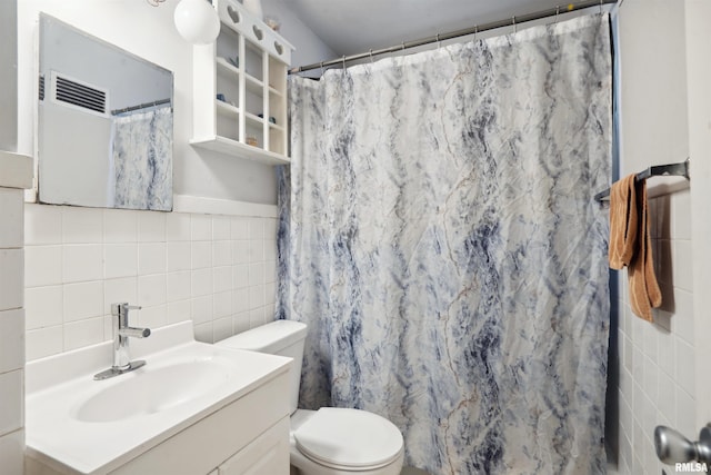 full bathroom featuring toilet, curtained shower, tile walls, and vanity