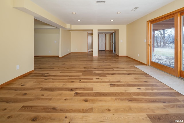 spare room with recessed lighting, light wood-type flooring, baseboards, and visible vents