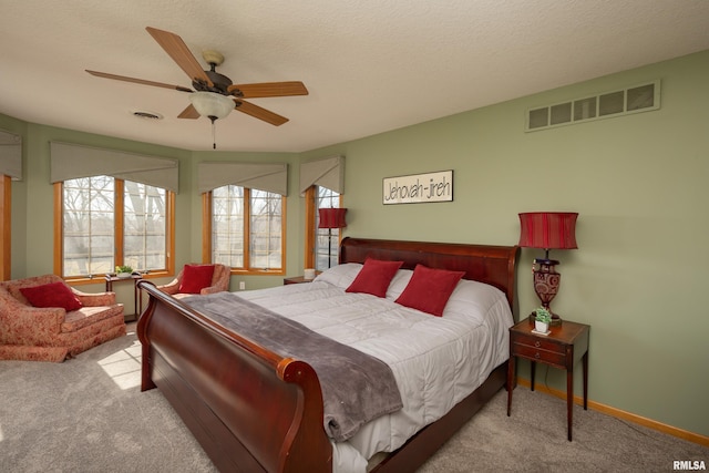 bedroom featuring carpet flooring, baseboards, visible vents, and ceiling fan