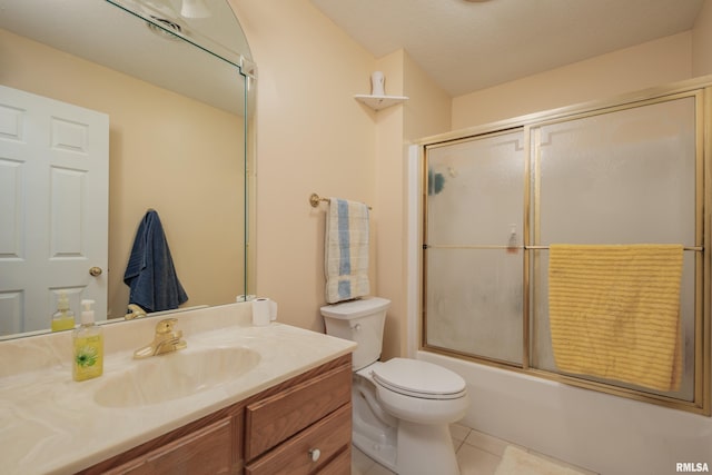 full bathroom with vanity, tile patterned floors, toilet, and combined bath / shower with glass door