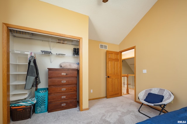 carpeted bedroom featuring lofted ceiling, baseboards, and visible vents