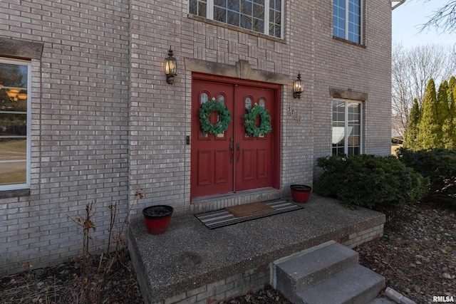 doorway to property with brick siding