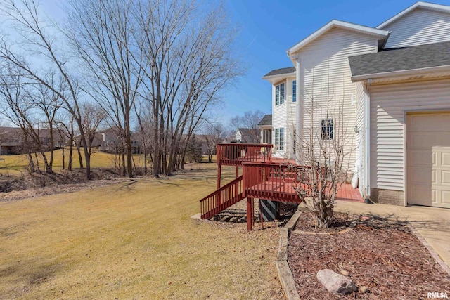 view of yard featuring driveway and a deck