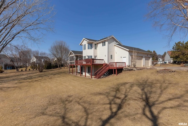 view of side of home with a yard, stairway, a wooden deck, and a garage