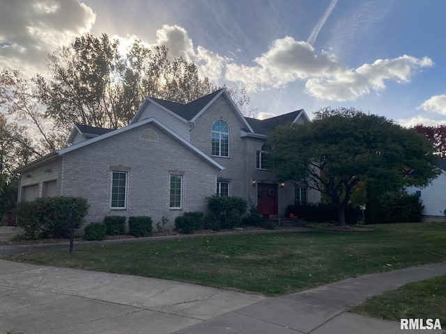 view of front of property with a front yard and brick siding