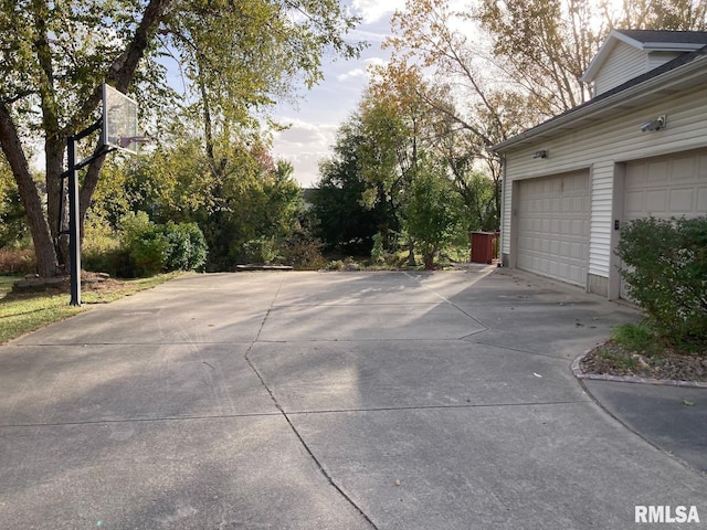 garage featuring concrete driveway