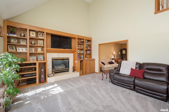 living room featuring carpet, high vaulted ceiling, and a tile fireplace