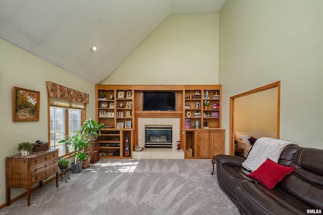 carpeted living room featuring a fireplace and high vaulted ceiling