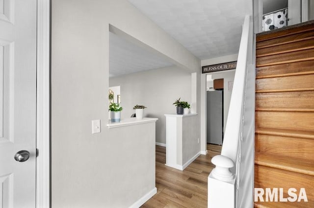 stairs featuring baseboards and wood finished floors