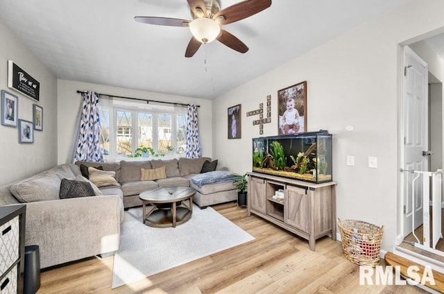 living area with light wood finished floors and a ceiling fan