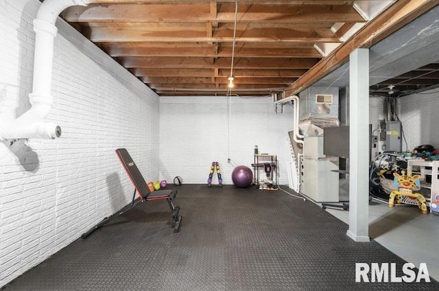 workout room with visible vents and brick wall