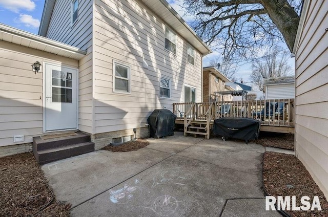 exterior space with a deck, entry steps, and grilling area