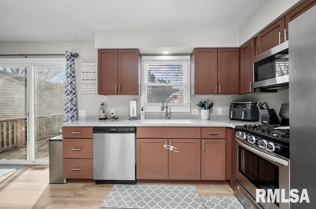 kitchen featuring light countertops, plenty of natural light, appliances with stainless steel finishes, and a sink