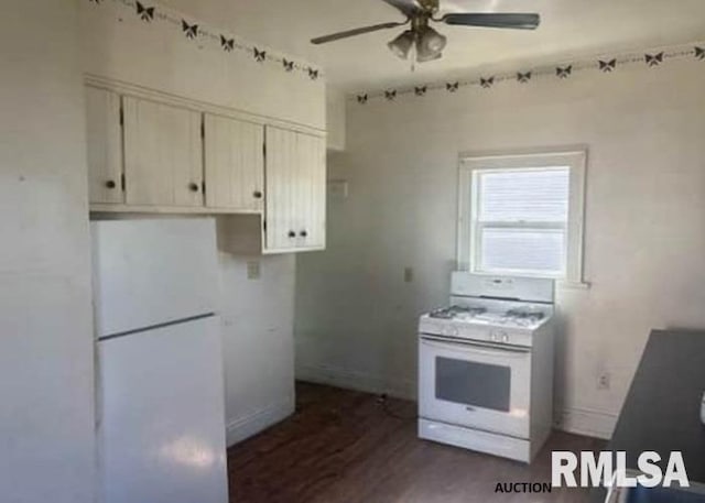 kitchen featuring dark wood-type flooring, a ceiling fan, white appliances, white cabinets, and baseboards