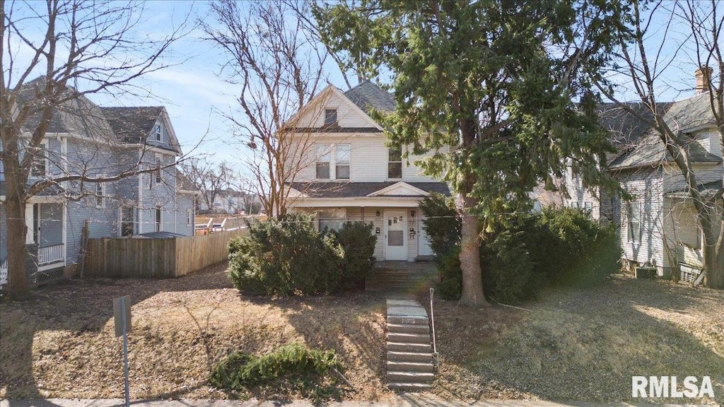 view of front of home featuring fence