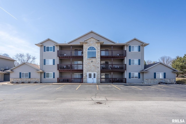 view of building exterior with uncovered parking