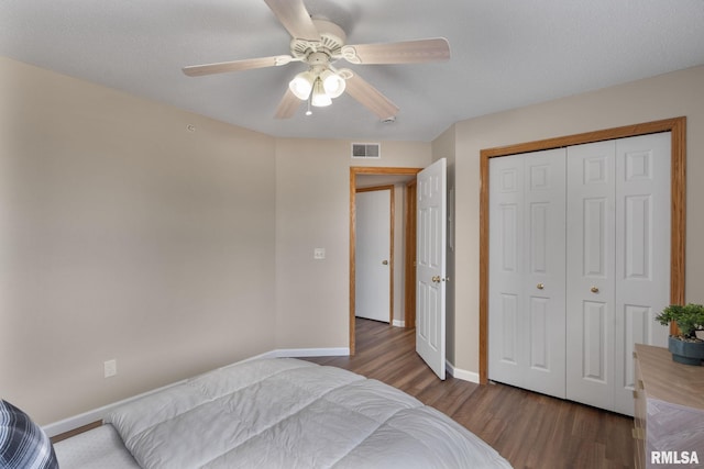 bedroom with visible vents, a ceiling fan, baseboards, and wood finished floors