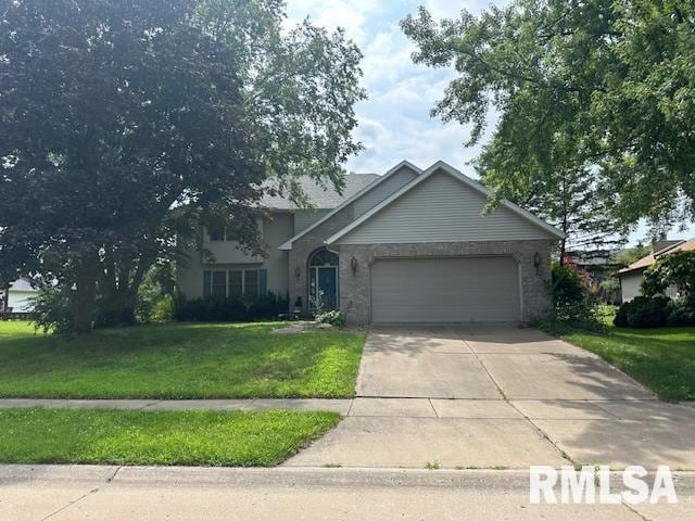 view of front of property with an attached garage, driveway, and a front yard