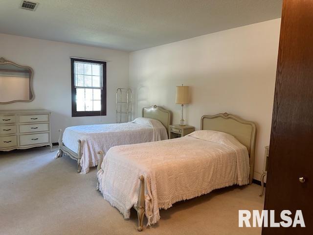 carpeted bedroom with visible vents