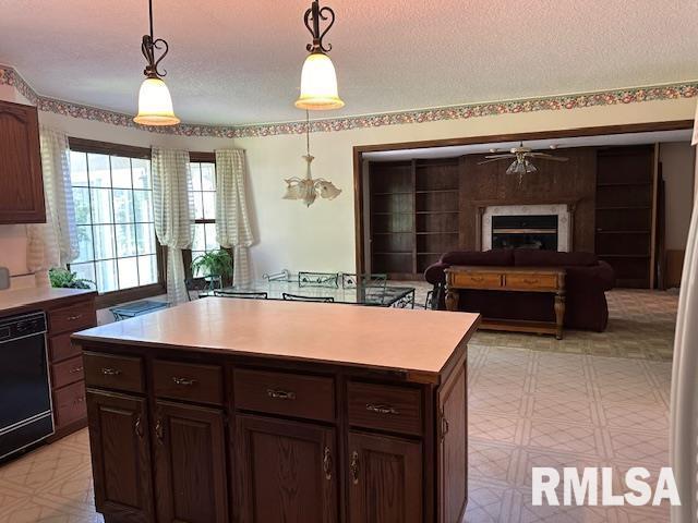 kitchen with light countertops, black dishwasher, light floors, and a textured ceiling