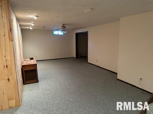 basement featuring a textured ceiling