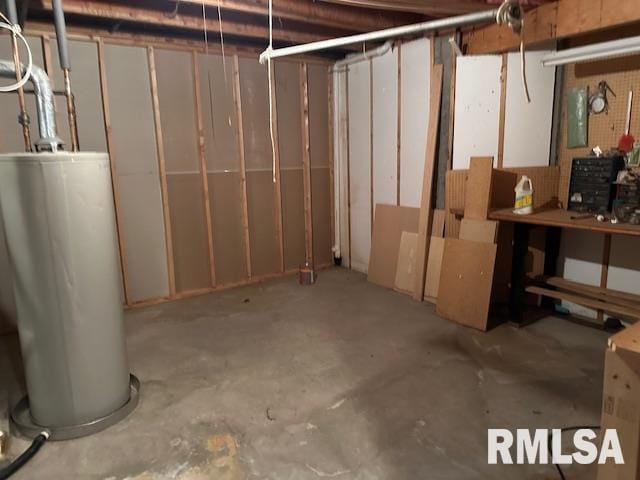 unfinished below grade area featuring water heater