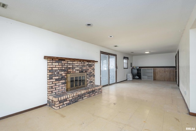 unfurnished living room featuring visible vents, a fireplace, and baseboards