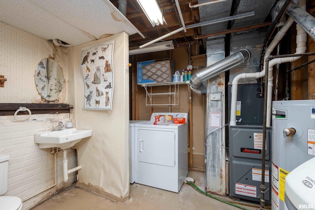 interior space with gas water heater, wallpapered walls, and separate washer and dryer