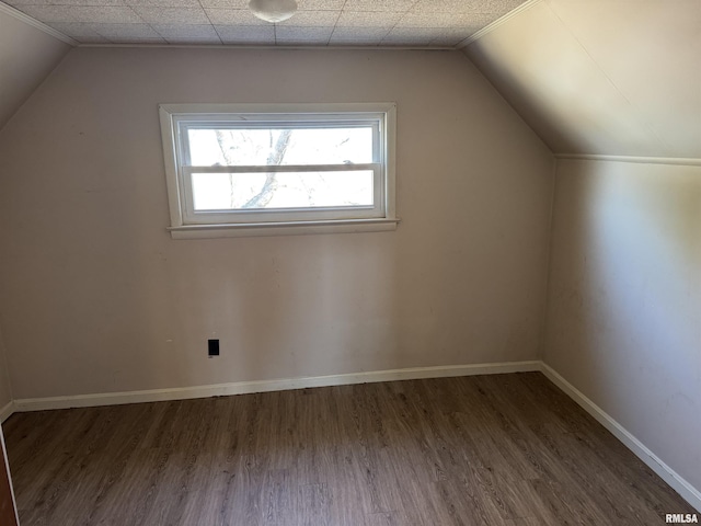 bonus room featuring lofted ceiling, baseboards, and wood finished floors