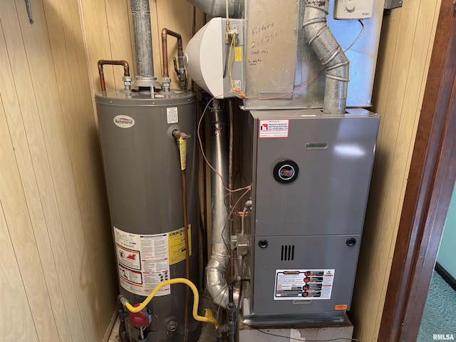 utility room with gas water heater and heating unit