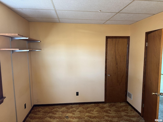 interior space with carpet, visible vents, a drop ceiling, and baseboards