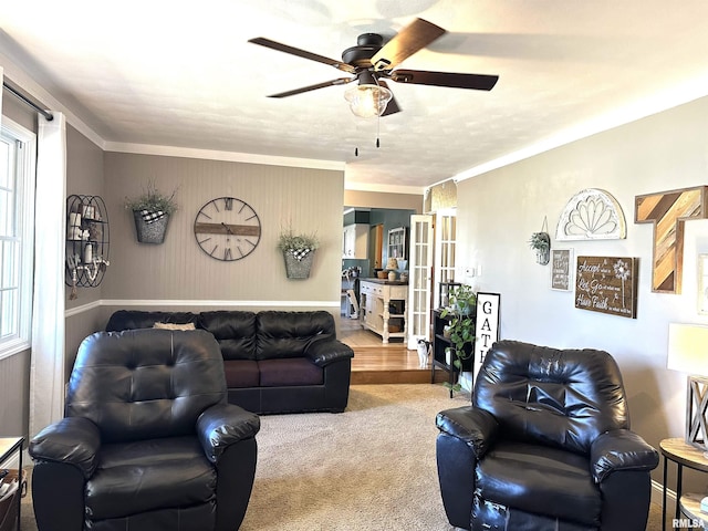 living room with french doors, crown molding, a ceiling fan, and carpet floors