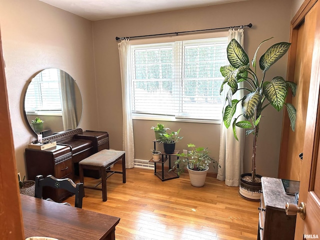 living area with light wood-style flooring and baseboards