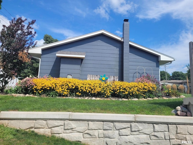 view of property exterior featuring a chimney