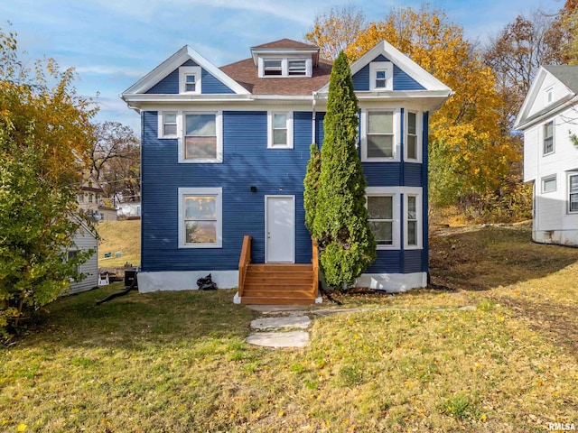 view of front of property with entry steps and a front yard