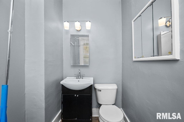 half bath with vanity and toilet