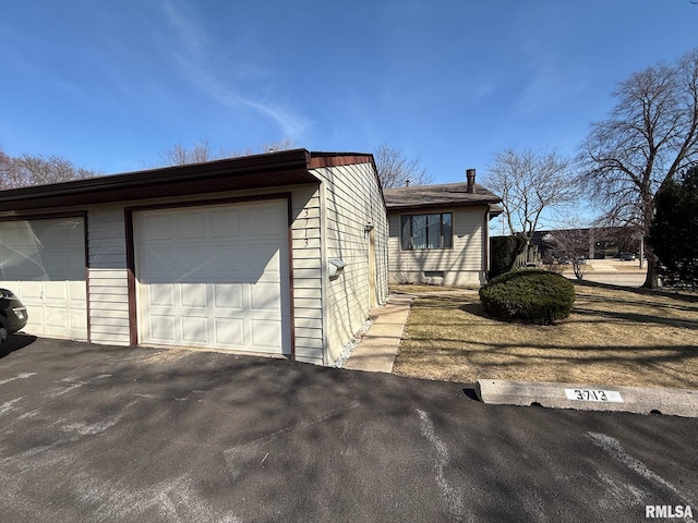 view of side of home with a garage