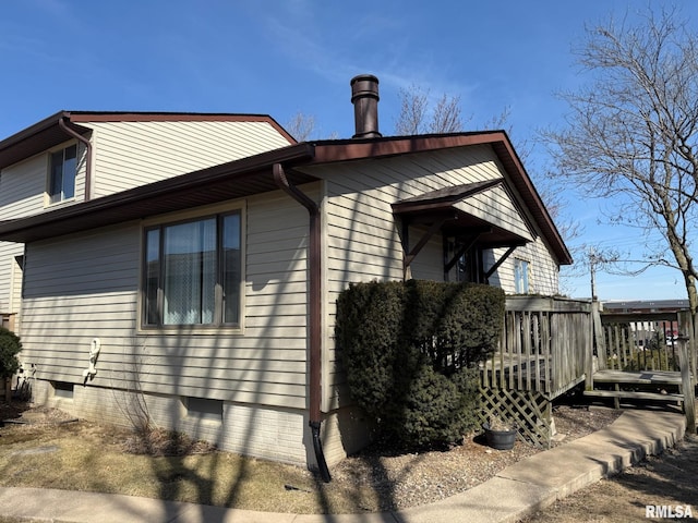 view of property exterior featuring a wooden deck