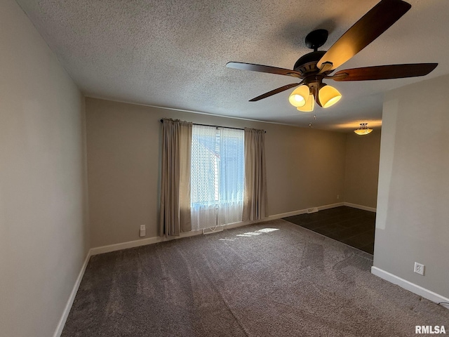 unfurnished room featuring baseboards, carpet floors, a textured ceiling, and ceiling fan