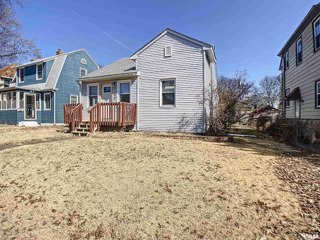 back of property with a gambrel roof and roof with shingles