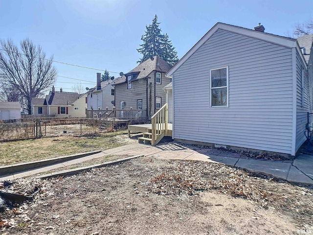 back of house with fence