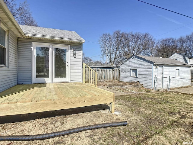 deck featuring an outbuilding and fence