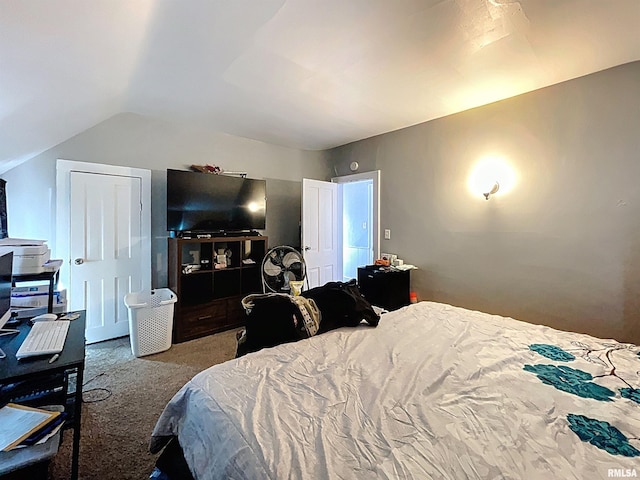 bedroom featuring vaulted ceiling and carpet flooring