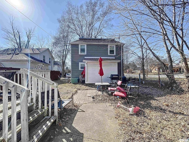 rear view of property featuring fence